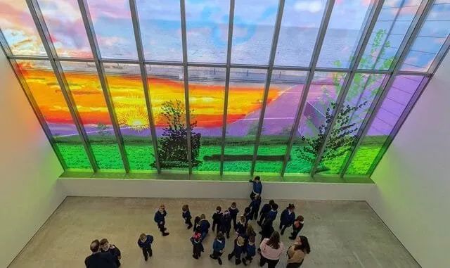 The Sunley Window at Turner Contemporary: a Hockney sunrise filling the gallery's floor-to-ceiling window, seen from above with visitors below