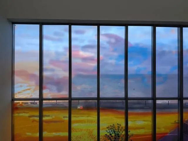 The Sunley Window from inside the gallery, with Margate seafront and the real sky visible through the painted glass