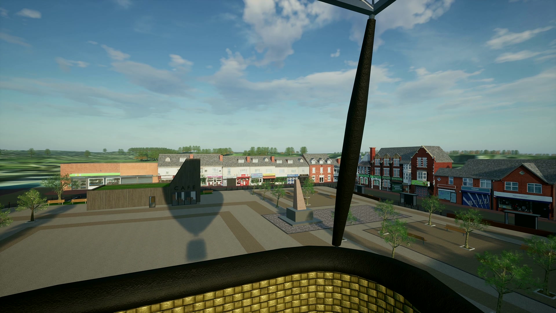 From the basket of the virtual hot-air balloon, rising over Shirebrook market square, with the balloon&rsquo;s shadow on the ground and the high street beyond